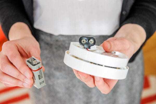 Woman holding smoke alarm