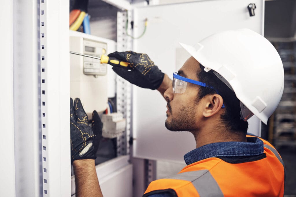 Electrician working on switchboard