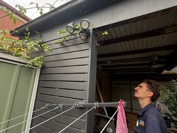 Captain Cook Electrical electrician inspecting the exterior of a home.